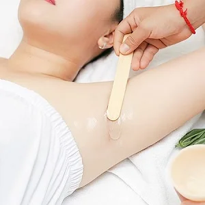 Warm wax being applied during an arm waxing treatment